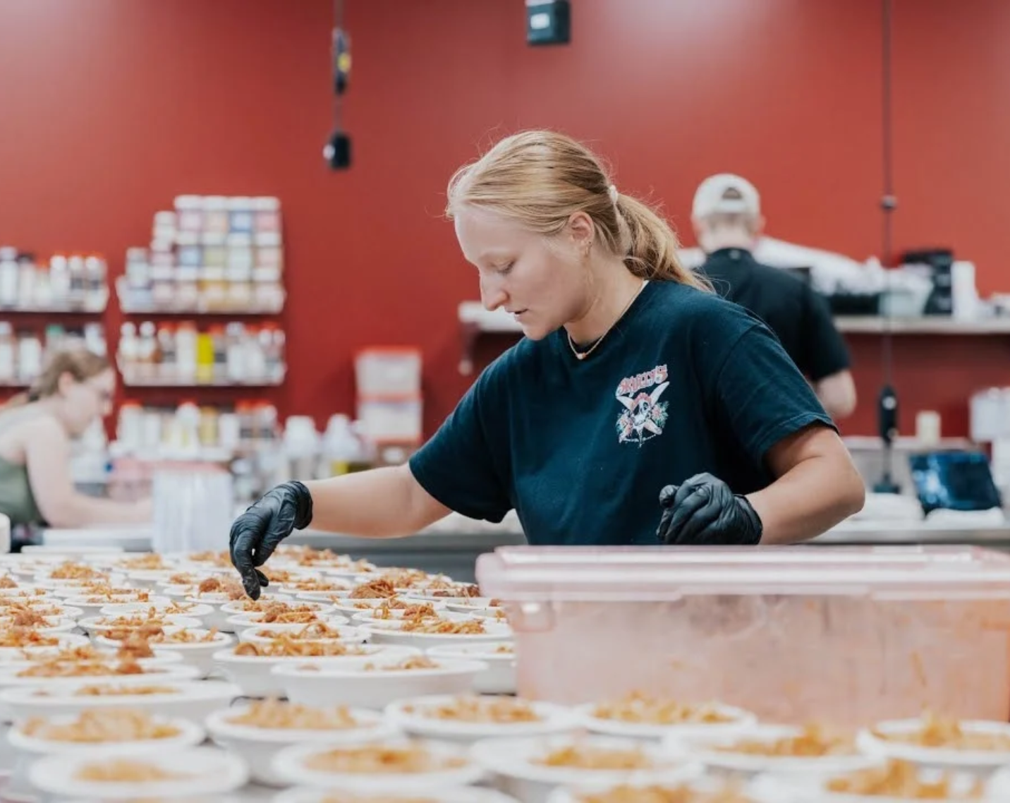 A member of the dining services team serving meals. 